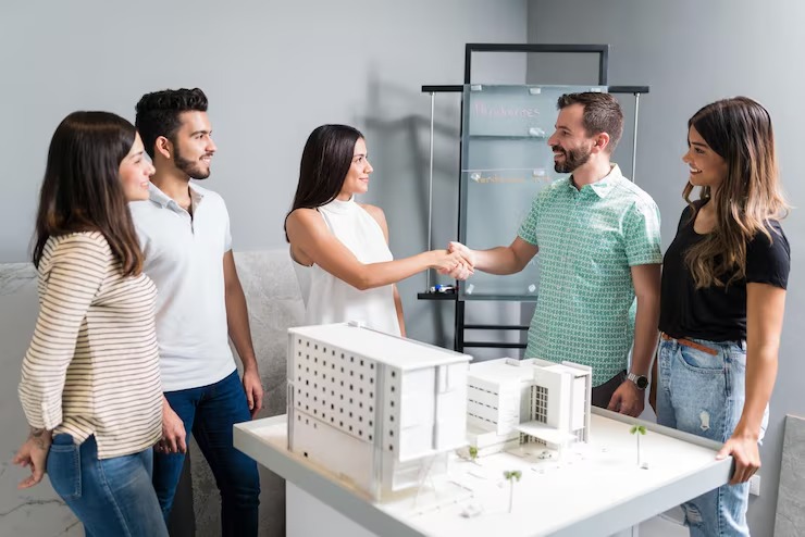 imgi_5_business-partners-shaking-hands-with-engineer-by-architectural-model-meeting_662251-1666